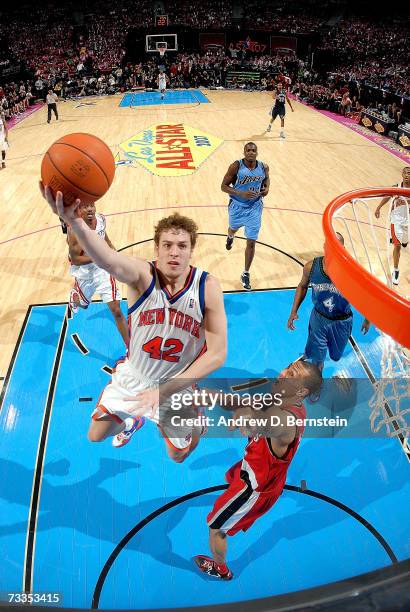 David Lee of the Sophomore Team lays the ball up in front of Brandon Roy of the Rookie Team in the second half of the T-Mobile Rookie Challenge at...