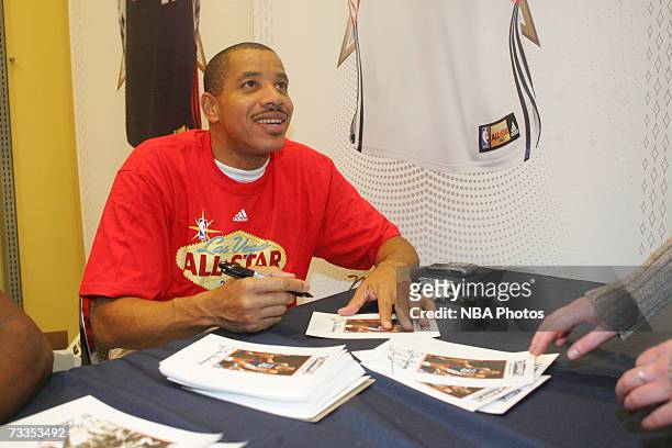 Former NBA star Otis Birdsong signs autographs and greets customers at the Champs Sporting Goods store during NBA All-Star Week festivities at the...