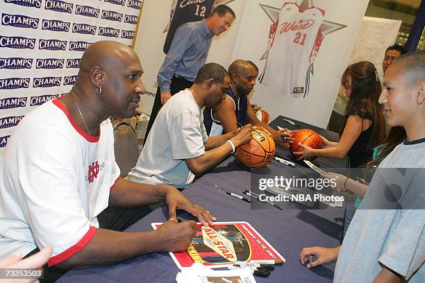 Former NBA star Daryl Dawkins signs autographs and greets customers at the Champs Sporting Goods store during NBA All-Star Week festivities at the...