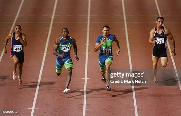 Patrick Johnson of Australia, Shawn Crawford of the USA, Joshua Ross of Australia and Chris Donaldson of New Zealand compete in the Men's 100 metre...