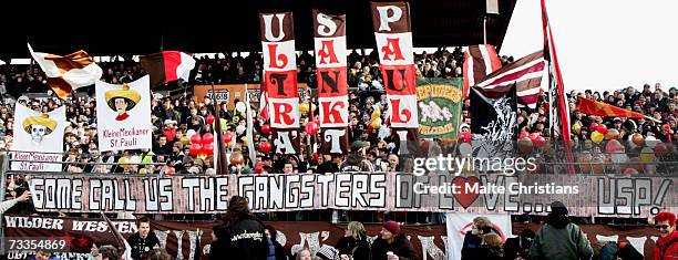 Fans of FC St. Pauli wave banners during the Third League match between FC St.Pauli and VFB Luebeck at the Millerntor stadium on February 17, 2007 in...