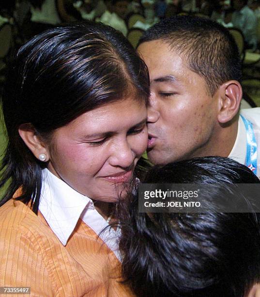 One of 26 Filipino seamen whose vessel was seized last month by gunmen in Nigeria's oil region, Joven Hidalgo , kisses his wife Maris after he was...