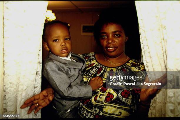 The Prime Minister of Rwanda Agathe Uwilingiyimana and her son Charles-Théophile, 2 years old.