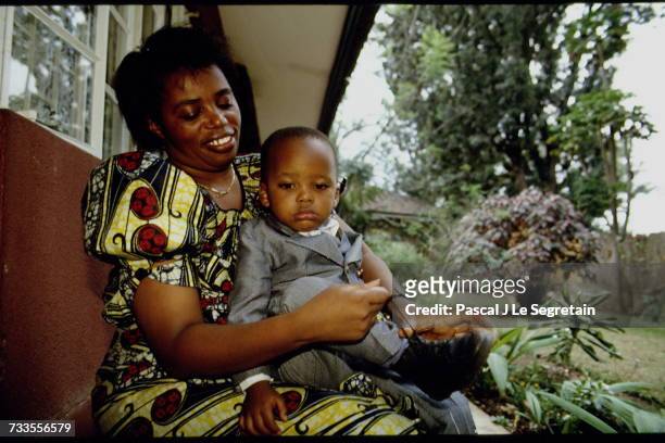 The Prime Minister of Rwanda Agathe Uwilingiyimana and her son Charles-Théophile, 2 years old.