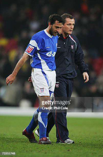 Jim Magilton manager of Ipswich Town consoles captain Sylvain Legwinski following the FA Cup sponsored by E.ON 5th Round match between Watford and...