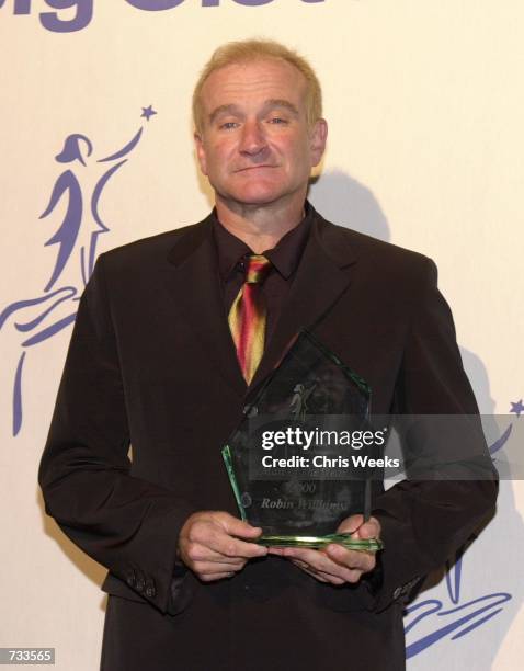 Actor Robin Williams, honored with "Man of the Year," poses for photographers at the Big Sisters of Los Angeles'' "Rising Stars 2000" October 26,...