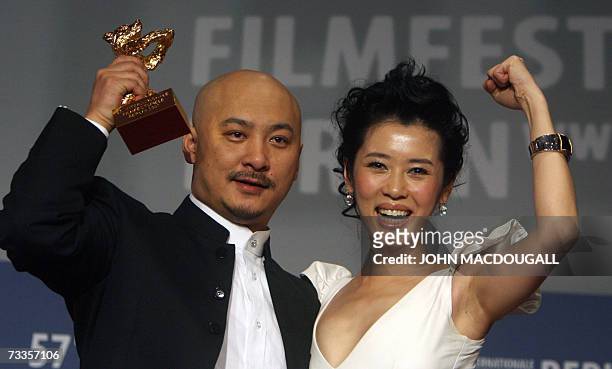 Chinese director Wang Quan'an and his lead actress Nan Yu celebrate with the Golden Bear for best film for his film Tuya's Mariage, during the...