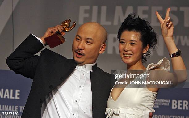 Chinese director Wang Quan'an and his lead actress Nan Yu celebrate with the Golden Bear for best film for his film Tuya's Mariage, during the...