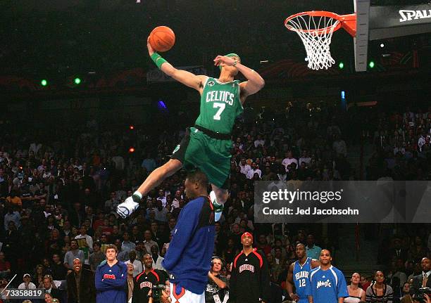 Gerald Green of the Boston Celtics leaps over fellow competitor Nate Robinson of the New York Knicks in the Sprite Slam Dunk Competition during NBA...