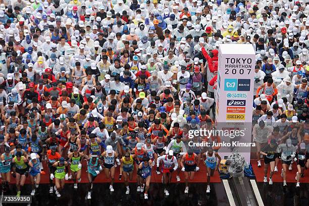 Participants start the Tokyo Marathon 2007 on February 18, 2007 in Tokyo, Japan. Some 30,000 people participated in the marathon through Tokyo, past...