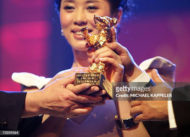 Chinese actress Nan Yu celebrates with the Golden Bear prize for best picture for the movie "Tu Ya De Hun Shi" by Chinese director Wang Quan'an...