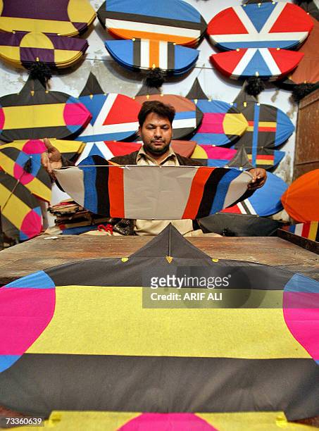 Pakistani shopkeeper makes new kites at a kite shop in Lahore, 18 February 2007, on the eve of The Basant Festival. Pakistani authorities have lifted...