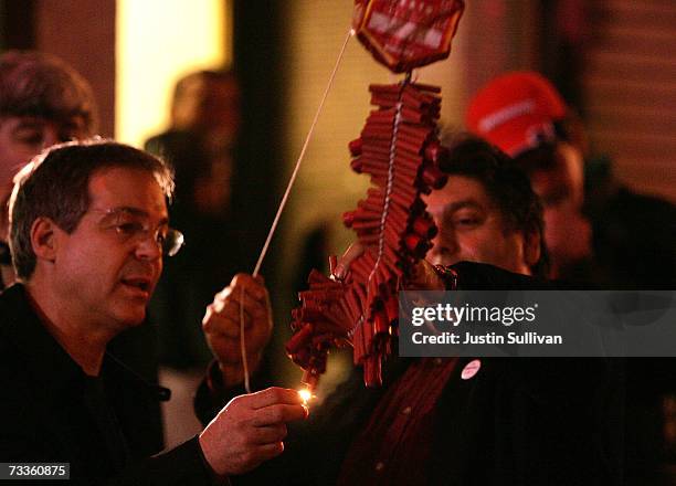 Revellers light a string of fire crackers in celebration of Chinese New Year shortly after midnight February 18, 2007 in the Chinatown neighborhood...