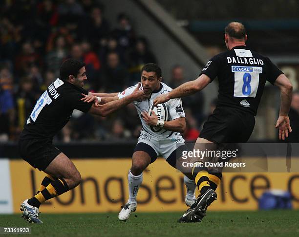Jason Robinson of Sale is tackled by Jeremy Staunton as Lawrence Dallaglio looks on during the Guinness Premiership match between London Wasps and...