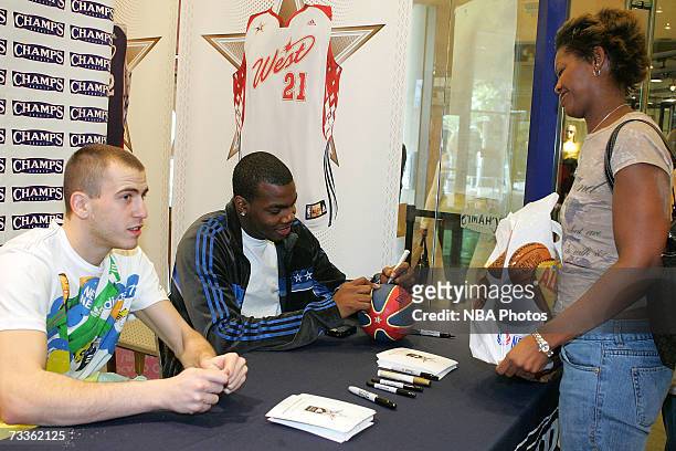 Sergio Rodriguez of the Portland Trail Blazers and Paul Millsap of the Utah Jazz sign autographs and greet customers during an appearance for NBA...