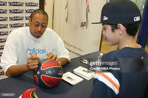 Donyell Marshall of the Cleveland Cavaliers signs autographs and greets customers during an appearance for NBA All-Star Week at Champs Sports Goods...