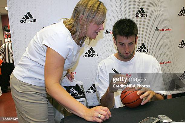 Jason Kapono of the Miami Heat signs autographs and greets customers during an appearance for NBA All-Star Week at Champs Sports Goods at the Las...