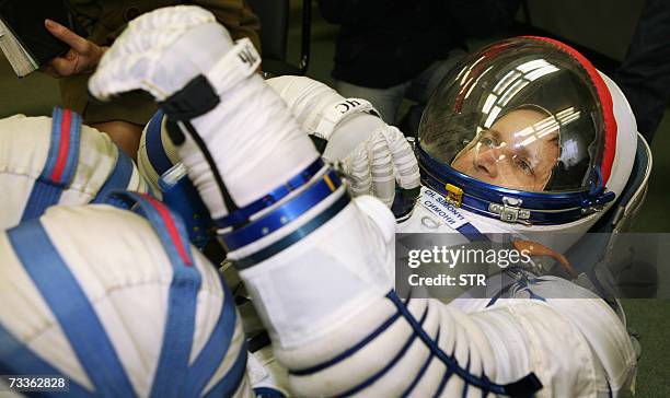 Moscow, RUSSIAN FEDERATION: Picture taken 22 January 2007 shows former Microsoft software developer Charles Simonyi trying on his space suit at a...