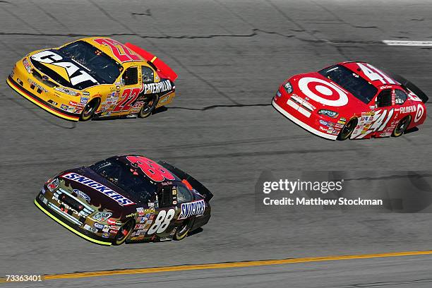 Ricky Rudd, driver of the Snickers Ford, leads Dave Blaney, driver of the Caterpillar Toyota, and Reed Sorenson, driver of the Target Dodge, during...