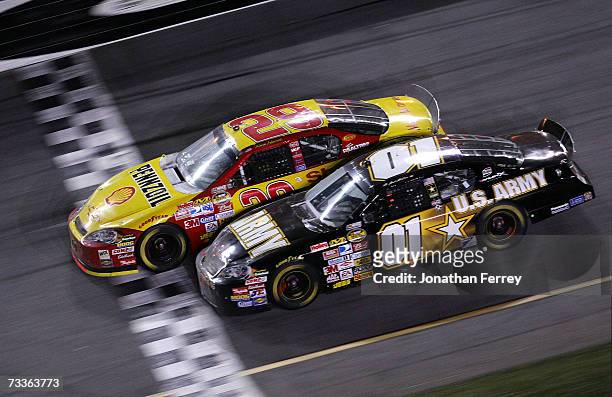 Kevin Harvick, driver of the Shell/Pennzoil Chevrolet, leads Mark Martin, driver of the U.S. ARMY Chevrolet, to the finish line to win the NASCAR...