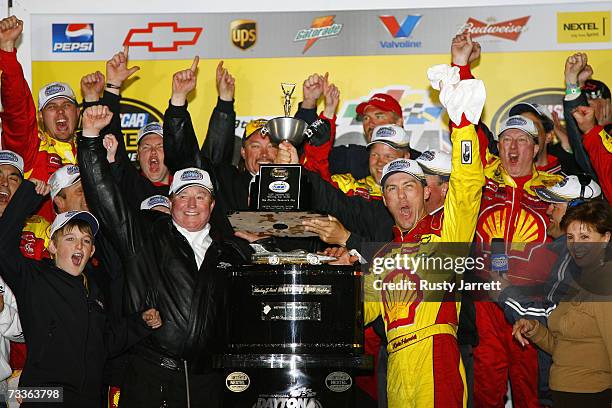 Kevin Harvick , driver of the Shell/Pennzoil Chevrolet, and team owner Richard Childress, celebrate in victory lane with team members, after winning...