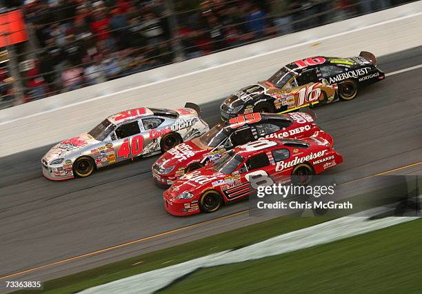 Dale Earnhardt Jr., driver of the Budweiser Chevrolet, races Carl Edwards, driver of the Office Depot Ford, David Stremme, driver of the Coors Lite...