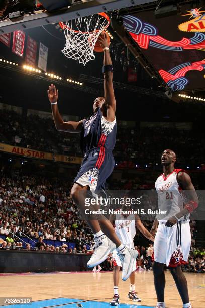 Joe Johnson of the Eastern Conference drives for a shot attempt against Kevin Garnett of the Western Conference during the 2007 NBA All-Star Game on...