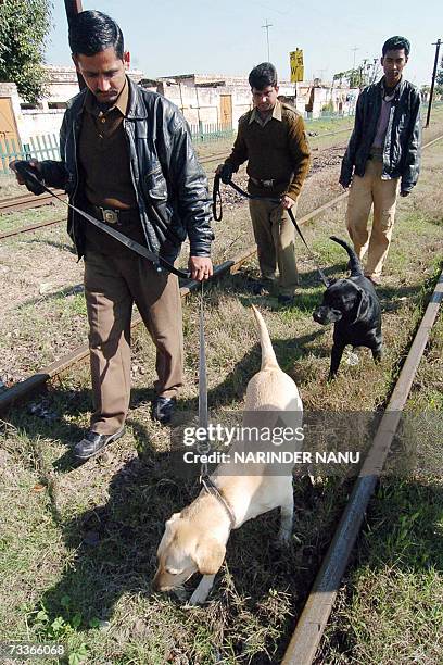 Indian security personnels patrol with sniffer dogs the railway tracks at the Atari railway station, 19 February 2007, after explosions aboard the...