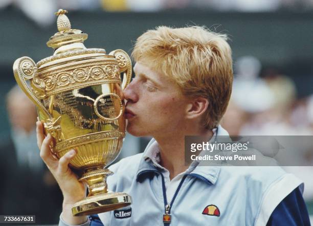 Boris Becker of Germany kisses the Gentleman's trophy to celebrate his victory over Kevin Curren 6-3, 6-7 , 7-6 , 6-4 during the Men's Singles final...