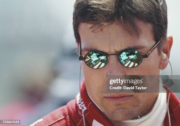The Firestone Patrick Racing Lola T96/00 Ford Cosworth is reflected in the sunglasses of driver Scott Pruett of the United States during the...