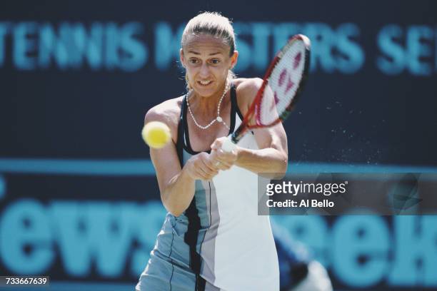 Mary Pierce of France makes a double backhand return against Martina Hingis during their Indian Wells Masters Women's Singles Semi Final match on 15...