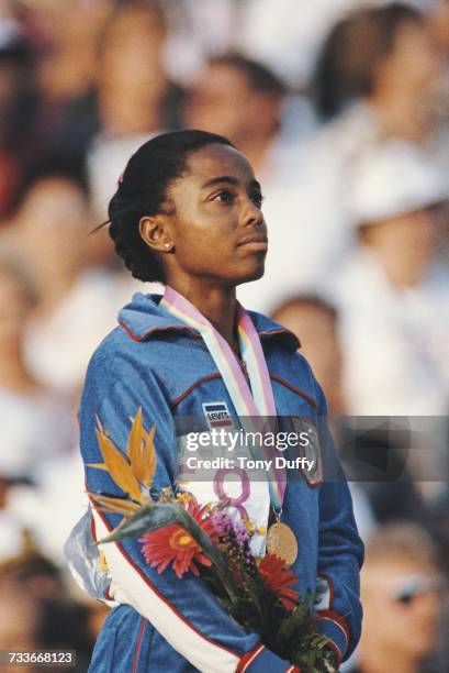 Evelyn Ashford of the United States stands on the podium after receiving her gold medal for winning the Women's 100m metres event at the XXIII...