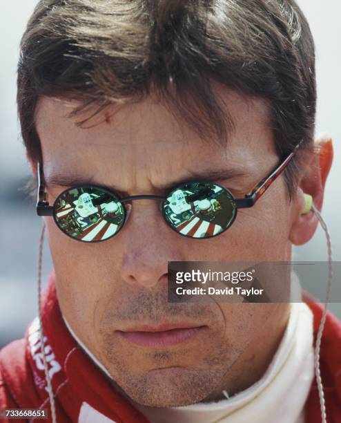 The Firestone Patrick Racing Lola T96/00 Ford Cosworth is reflected in the sunglasses of driver Scott Pruett of the United States during the...