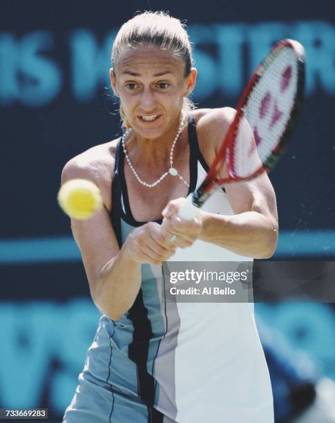 Mary Pierce of France makes a double backhand return against Martina Hingis during their Indian Wells Masters Women's Singles Semi Final match on 15...