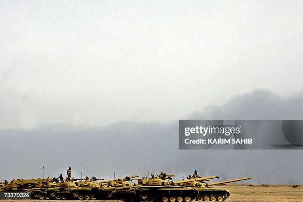 File picture dated 21 February 2006 shows Soviet model T-72 Iraqi tanks from the 9th Army Mechanized Division lining up during a training session at...