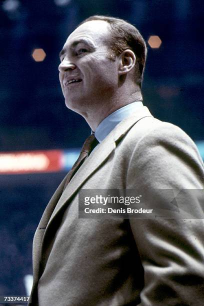 Headcoach Red Kelly of the Pittsburgh Penguins looks on from the bench during a game.
