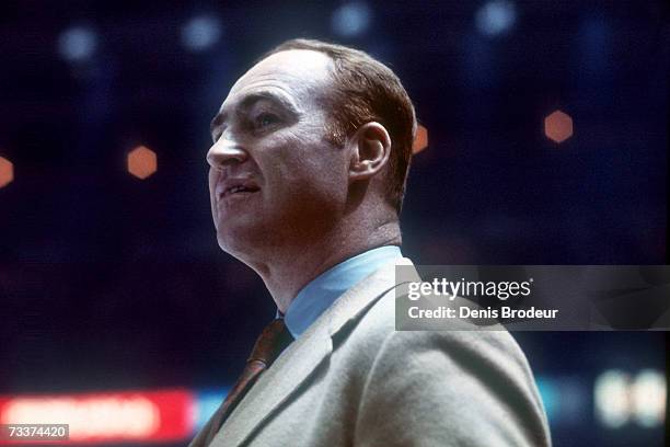 Headcoach Red Kelly of the Pittsburgh Penguins looks on from the bench during a game.