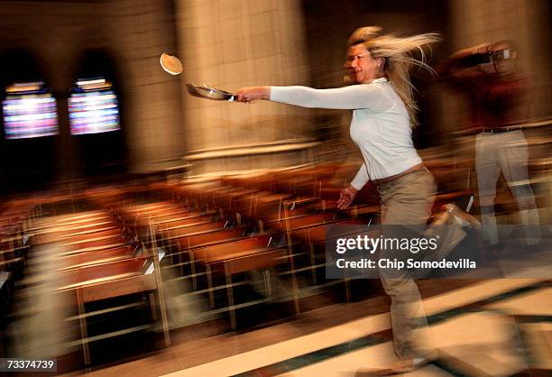 National Cathedral worship department administrative assistant Anna Alston Donnelly tries to flip a pancake while racing up and down the National...