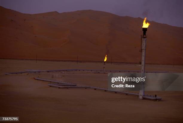 Flare stacks burn at the Saudi Aramco oil field complex facilities at Shaybah in the Rub' al Khali desert on March 2003 in Shaybah, Saudi Arabia.