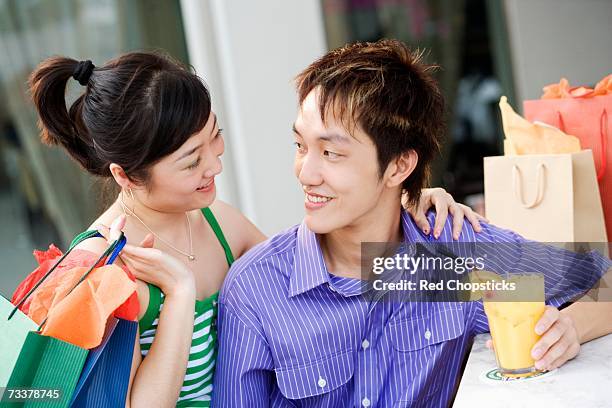 close-up of a young couple looking at each other and smiling - rietje los stockfoto's en -beelden