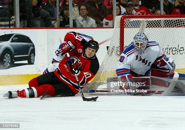 Eric Rasmussen Eric Rasmussen of the New Jersey Devils falls to the ice trying to ...