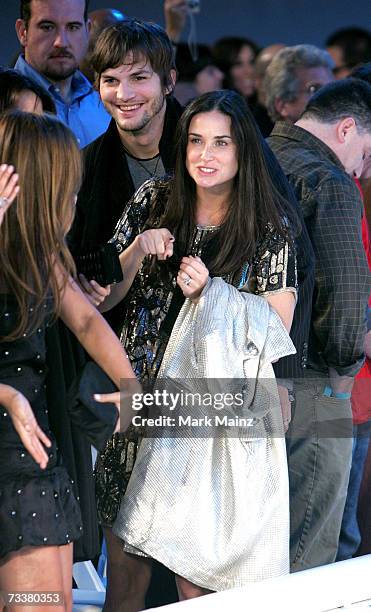 Actors Ashton Kutcher and Demi Moore walk to their seats at the 6th Annual General Motors TEN event at Paramount Studios on February 20, 2007 in Los...