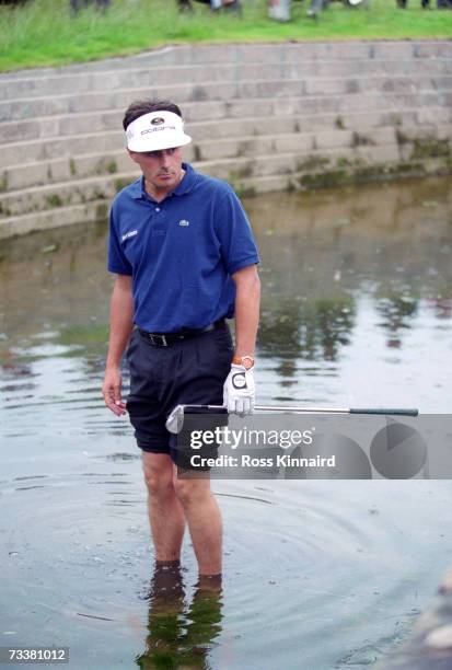 French golfer Jean Van de Velde wades into Barry Burn by the 18th green after his 3rd shot went astray in the final round of the British Open...