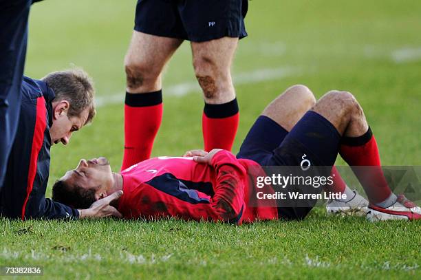 Jason Robinson of England receives treatment after making a tackle during an England rugby training session at Bath University on February 21, 2007...