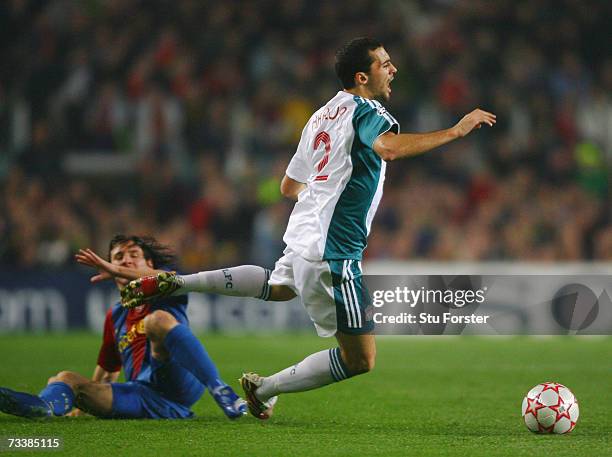 Lionel Messi of Barcelona fouls Liverpool defender Alvaro Arbeloa during the UEFA Champions leagueRound of 16 first leg match between Barcelona and...