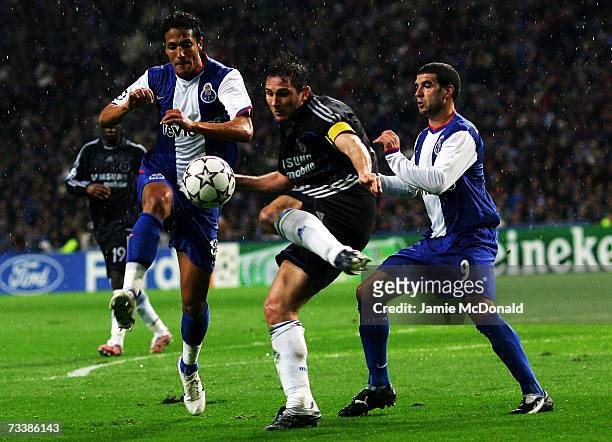 Frank Lampard of Chelsea is challenged by Lisandro Lopez and Paulo Assuncao of Porto during the UEFA Champions League, round of sixteen first leg...