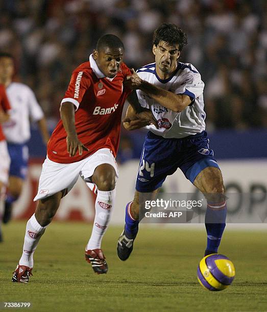 Luiz Adriano of Internacional and Alexis Viera of Nacional vie for the ball 21 February 2007 during their Libertadores Cup football match in...