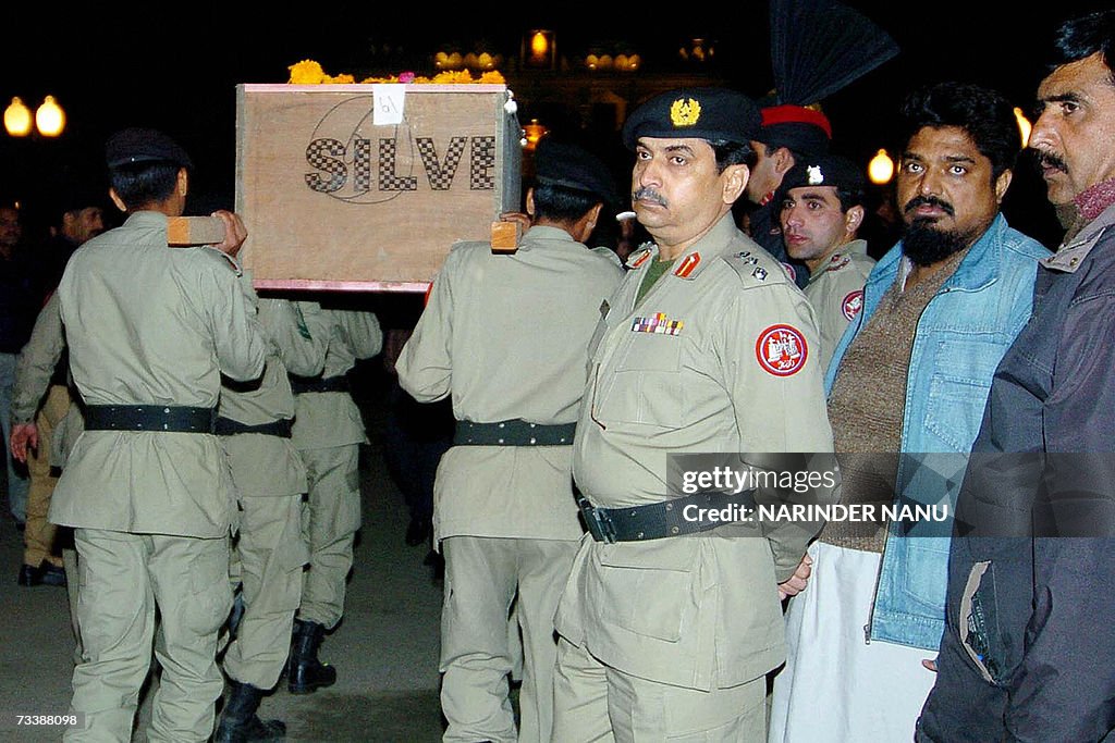 Pakistani paramilitary rangers carry a coffin past grieving relatives ...