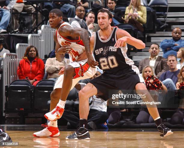 February 21: Marvin Williams of the Atlanta Hawks battles for position against Manu Ginobili of the San Antonio Spurs at Philips Arena on February...