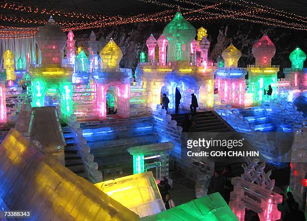Visitors enjoy the Ice Lantern Festival in Longqingxia, in Beijing's Yanqing county, 21 February 2007, that will close early this year due to rising...